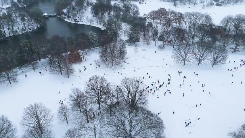 Static aerial shot of people sledding in Piedmont Park Atlanta.