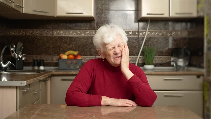 Senior female feel teeth pain. Senior grey haired woman painful expression touching mouth because of toothache or dental illness on teeth, oral health care. Flabby and wrinkled skin on senior female
