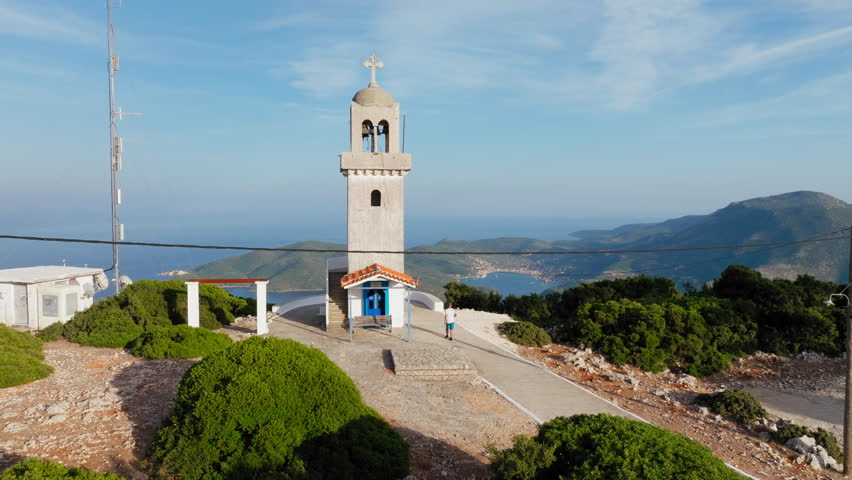 Following one man near the bell tower of Panagia Kathariotissa Monastery in Ithaca island, Greece
