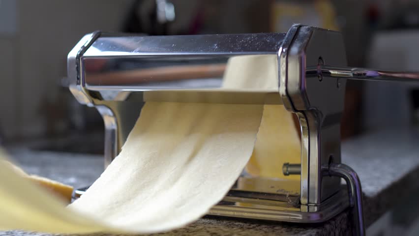 Preparing Homemade Pasta Using Pasta Machine - Close Up