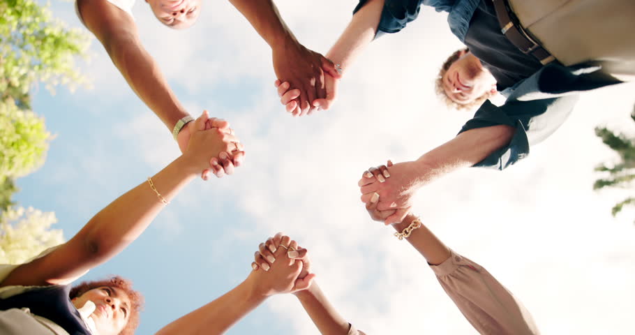 Celebration, holding hands and people with success, support and accomplishment for colleagues, unity and team. Solidarity, low angle and group of employees with victory, achievement and collaboration