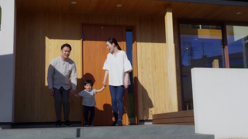 Family of three going out in front of their home
