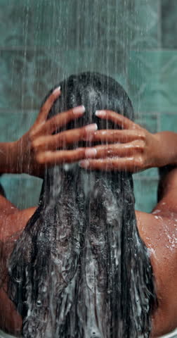 Back, woman and shower in home for hair care, cleaning and keratin treatment for wellness. Cosmetics, female person and water with conditioner for hydration, washing and shampoo for hygiene in house