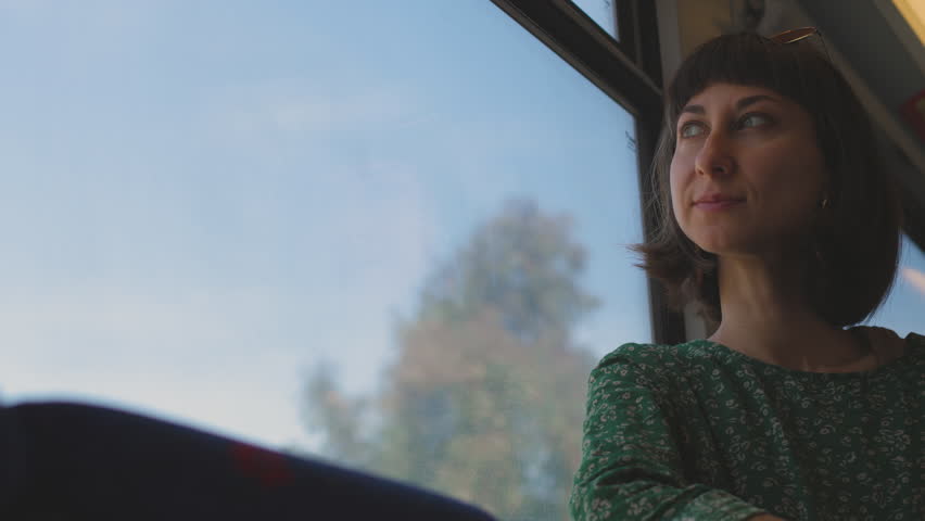 girl with camera. young beautiful girl with camera takes pictures from train window. train travel. train passenger.