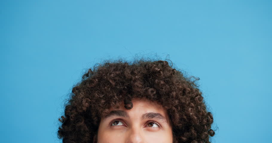 Thinking, mockup and eyes of man in studio for decision, announcement and reflection. Solution, problem solving and choice with closeup of person and space on blue background for idea and question