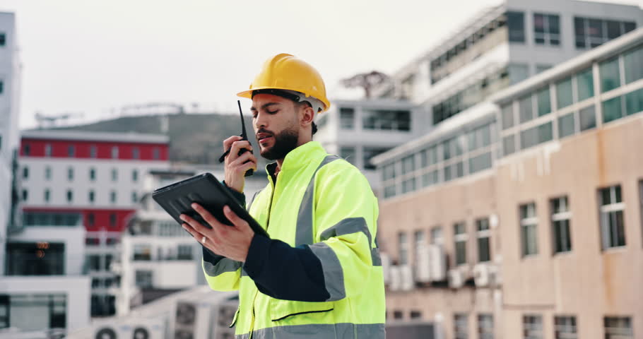 Man, radio and building inspection at construction site with tablet, contact and quality assurance in city. Person, engineer and talking with touchscreen, notes and app for safety assessment in Chile