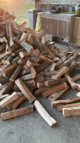 heap of firewood being delivered to home with tractor