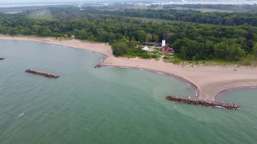 Presque Isle from the air—sweeping aerial footage captures the sandy beach, the vast Lake Erie, and the surrounding trees that complete this peaceful landscape.