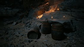 Dim light from candles flickers against rough cave walls, revealing two barrels placed on sandy ground. The atmosphere is serene yet mysterious in this secluded location. - Powered by Shutterstock - Get 15% off with code: PIKWIZARD15