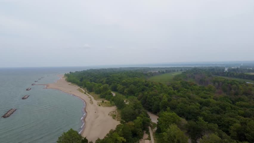Fly above Presque Isle and witness its stunning coastline—soft sand beaches, dense forests, and the sparkling waters of Lake Erie from the sky.
