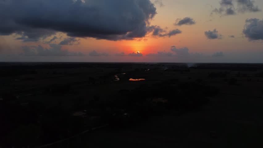 Sunset in india. Black clouds clouds over sunset. India. Sunset view in indian village area. Indian village.