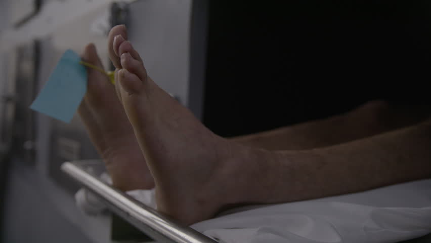 Morgue feet toe tag close up dead body