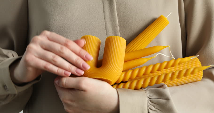 Woman with many different beeswax candles, closeup