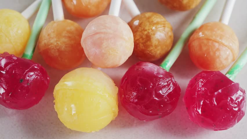 Bright colorful candies, lollipops on a white background rotating close-up. High quality 4k footage
