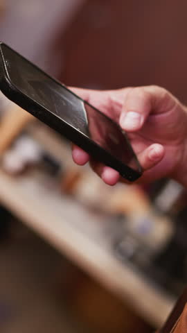 Person takes photo of simple men black leather wallet with cellphone in studio closeup. Master of manual manufacture shows product online