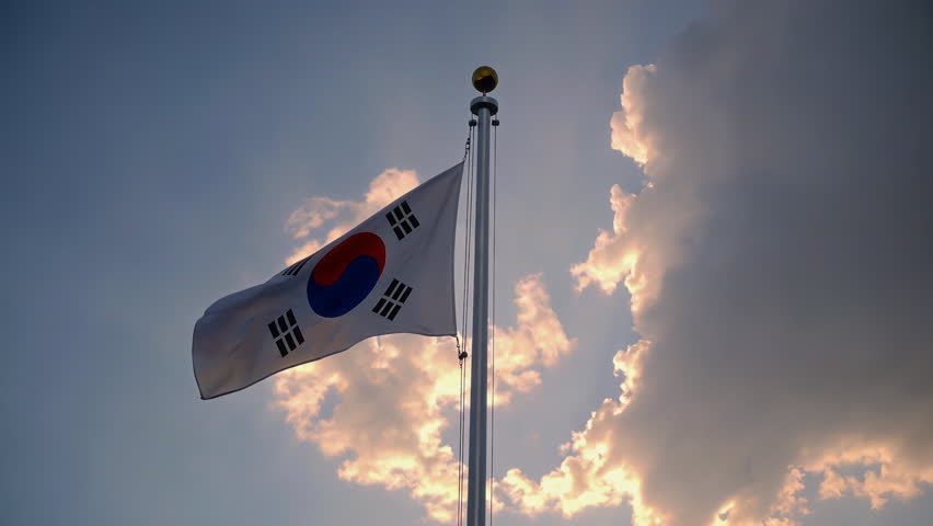 The South Korean flag flutters majestically in the sky, representing the national pride and unity of the country