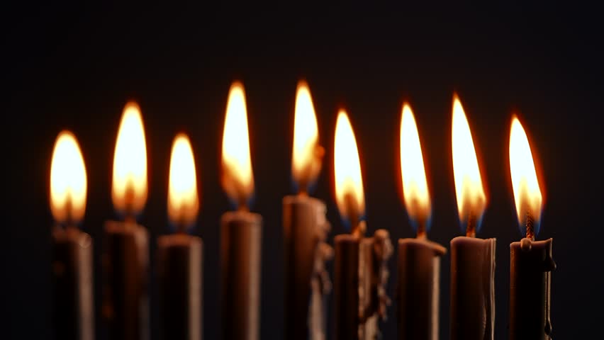 A beautifully lit menorah with glowing candles represents the warmth of Hanukkah, illuminating the festive atmosphere. This sacred ritual signifies faith and heritage in Jewish culture.