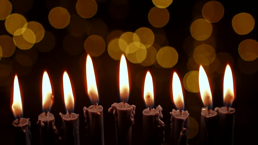 Nine candles burn on a dark festive background with a bokeh effect, symbolizing faith and tradition. The festive atmosphere captures the essence of Hanukkah celebrations and rituals.