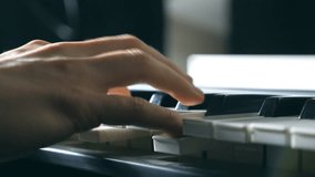 Close up fingers of pianist at the piano keys. Mens arms plays solo of music or new melody. Hands of male musician playing at synthesizer. Slow motion Top view Isolated shot - Powered by Shutterstock - Get 15% off with code: PIKWIZARD15