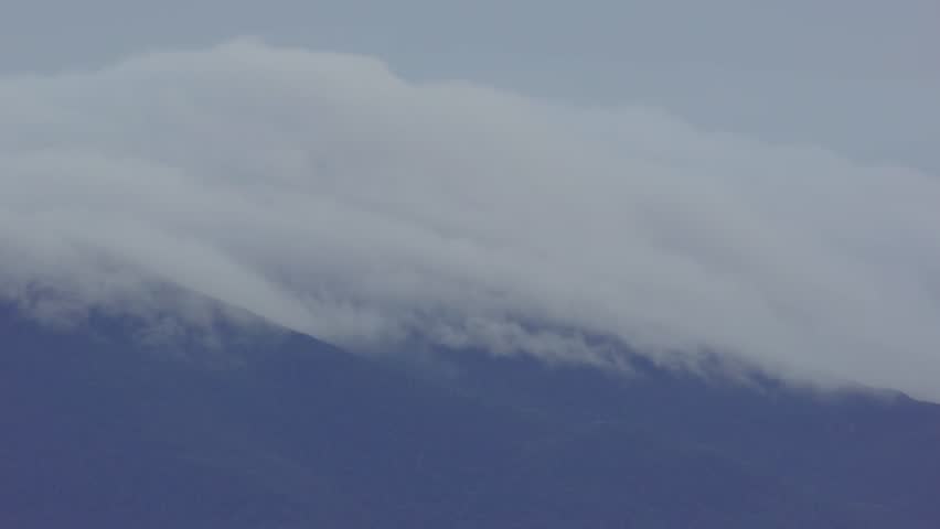 A captivating aerial view showcasing the sprawling Adirondack mountain meadows, with a dynamic cloudscape overhead, capturing the essence of wilderness and seasonal beauty.