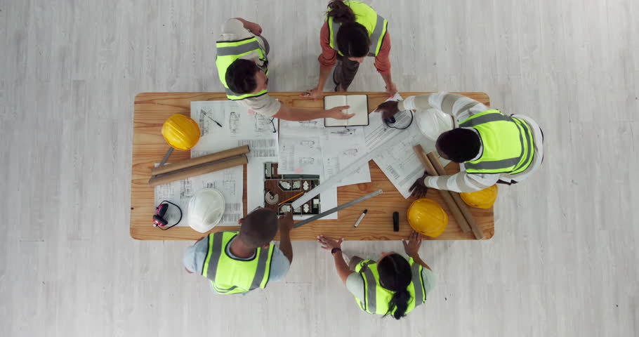 Top view, people and construction team with handshake, engineering and floor plan for house project. Employees, talk and collaboration on architecture design, greeting and introduction in office
