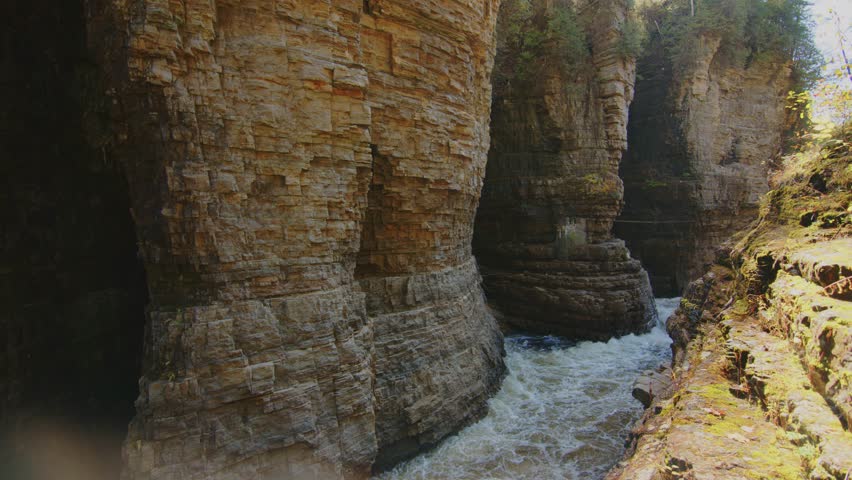 A captivating 4K video of the Ausable River cutting through a narrow gorge between towering walls of Potsdam Sandstone, located in the heart of Adirondack Park, New York.