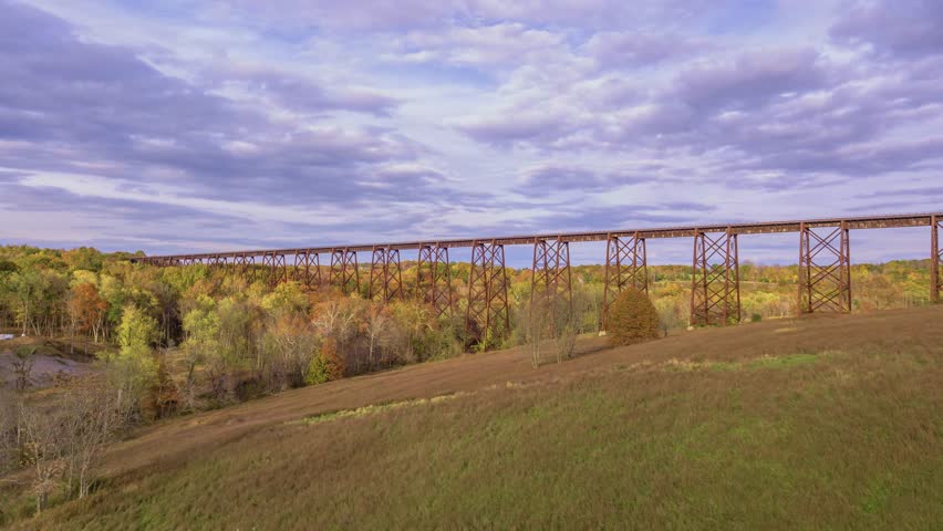 This 4K drone footage captures the majestic Moodna Viaduct, located in Salisbury Mills, NY, showcasing its architectural beauty and the surrounding scenic landscape.