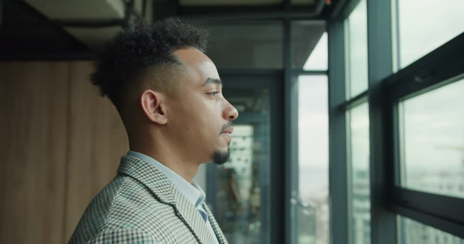 Businessman relaxing and taking a deep breath in an office.