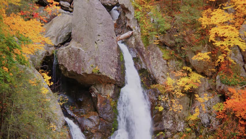 This footage shows the dramatic Bash Bish Falls in Bash Bish Falls State Park, the highest waterfall in Massachusetts, surrounded by lush fall foliage.