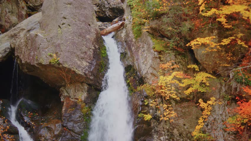 A stunning view of Bash Bish Falls in its full glory during the fall season, capturing the highest waterfall in Massachusetts, within Bash Bish Falls State Park.