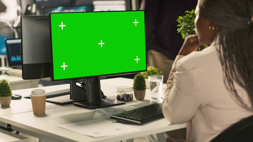 Office clerk working on green screen mockup PC to hit key performance targets for revenue and profitability. Employee at chroma key computer desk doing research analysis, camera A