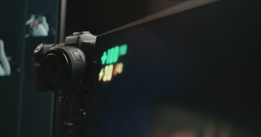 Video game live streamer adjusting microphone, camera, and stream 