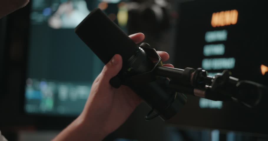 Video game live streamer adjusting microphone, camera, and stream 