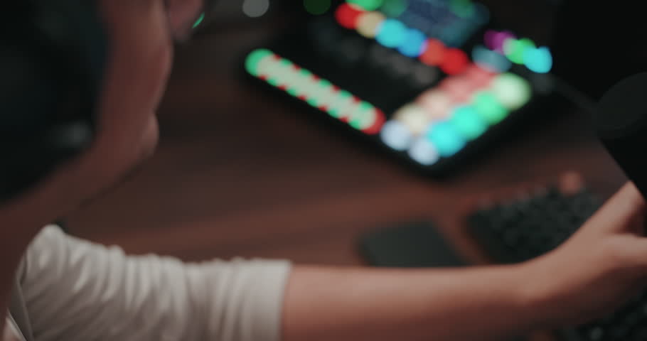 Video game live streamer adjusting microphone, camera, and stream 