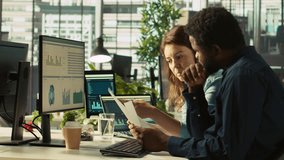 Manager at office desk next to accountant checking financial figures on documents, doing reports. Team leader and man working together crosschecking data on paperwork files, camera B - Powered by Shutterstock - Get 15% off with code: PIKWIZARD15