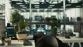 Business graphs and performance metrics on monitors in workplace, handheld camera shot. Office desk setup in bright corporate environment with monitors displaying data analytics, panning shot - Powered by Shutterstock - Get 15% off with code: PIKWIZARD15