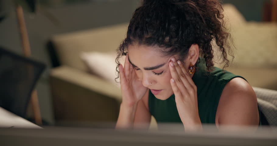 Computer, headache and stress with designer woman in home office at night for project deadline. Eye strain, migraine or remote work with creative employee at desk for programming or web development