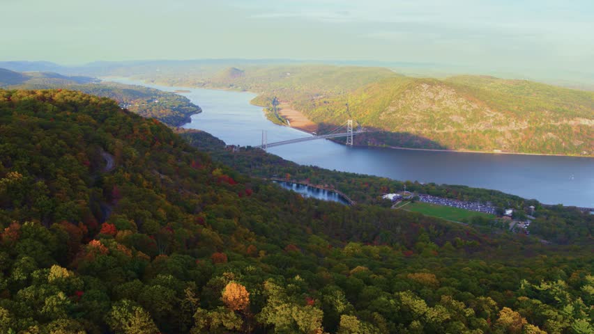 Captured in 4K, this footage showcases Bear Mountain State Park, featuring a serene lake and the natural beauty of the surrounding area under beautiful weather conditions.