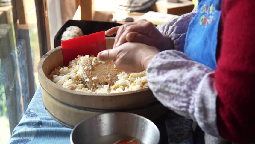 A woman making rice balls