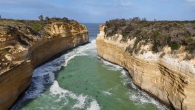 Aerial footage captures the stunning cliffs and turquoise waters of Loch Ard Gorge in Port Campbell, Australia, under bright daylight - Powered by Shutterstock - Get 15% off with code: PIKWIZARD15