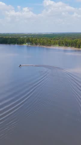 Boat circles on lake, creating waves and fun