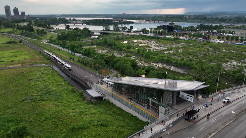 Aerial descent reveal of ottawa light rail train at station