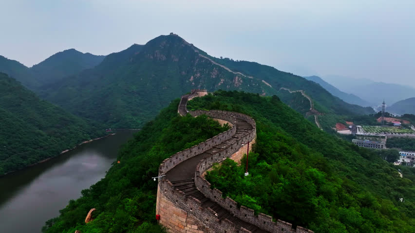 Aerial view following the Huanghuacheng Great Wall, cloudy, summer day in China