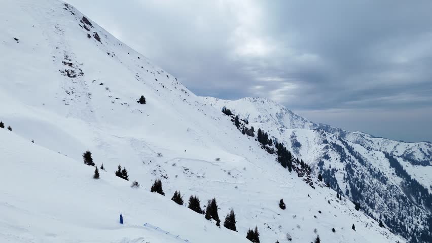 Aerial of snowy mountain range with snow