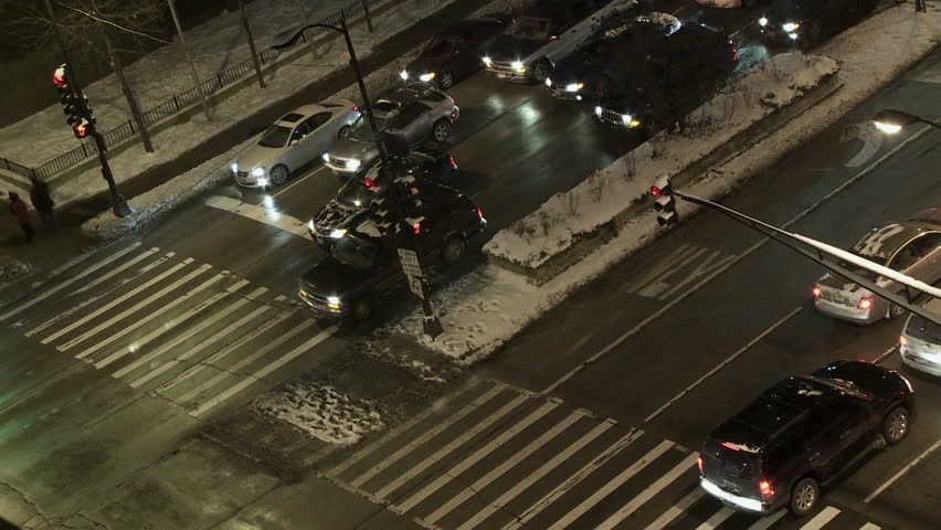 Sped up footage of a crosswalk in Chicago in winter, with traffic and