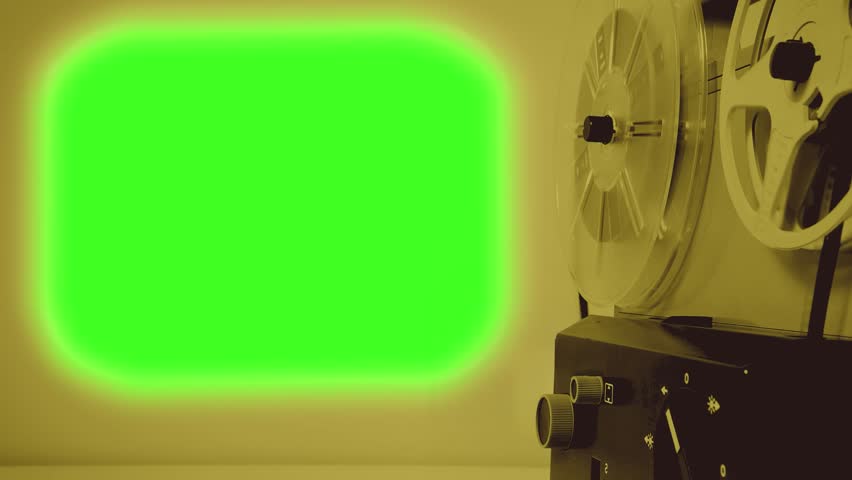 Movie projector 70s displays a green screen on the wall. Film strip rotations. Sound of mechanism