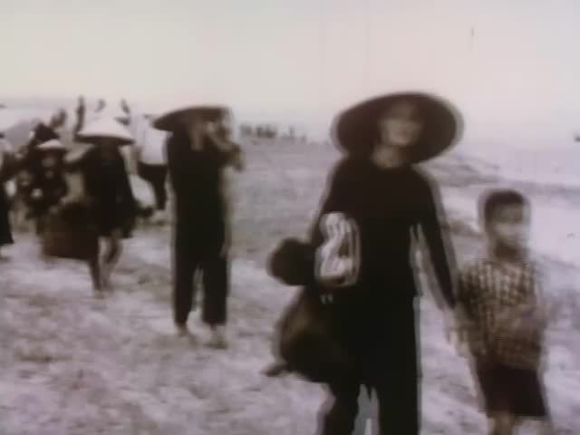Close-up vintage black and white footage of Vietnamese people evacuating. Vietnam - 1969.
