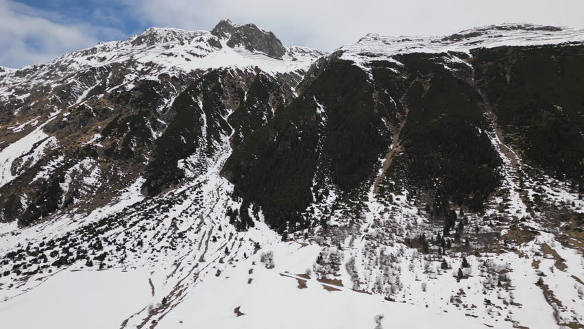 Massive snowy mountains in Austria, aerial view