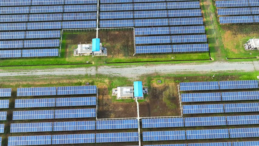 The drone captures a vast solar farm, highlighting the role of renewable energy in reducing carbon footprints and promoting environmental sustainability through clean, solar power generation.
