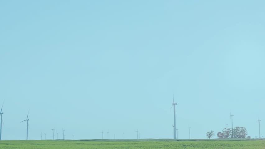 Wind turbines in green field with financial data processing animation overlay. Renewable, energy, sustainability, eco-friendly, innovation, technology - Powered by Shutterstock - Get 15% off with code: PIKWIZARD15